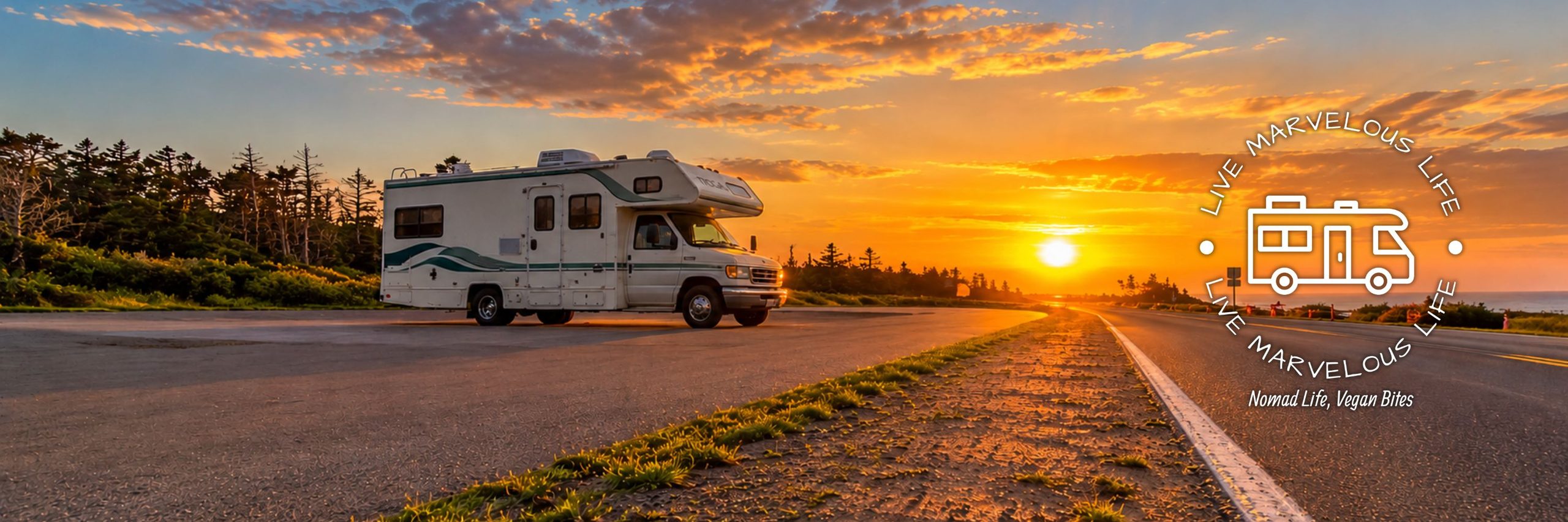 A motorhome parked along a coastal road at sunset, representing the freedom of full-time RV travel and life on the road in Canada.